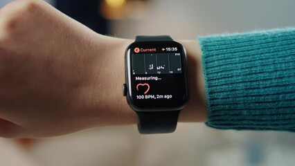 Woman using smartwatch close-up. Female person wearing fitness bracelet, checking heart rate, measuring pulse on wrist. - Powered by Adobe