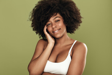 Smiling black woman with curly hair looking at camera