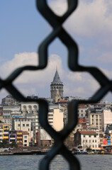 The Galata Tower through Galata Bridge's shutter in Istanbul, Turkey.