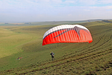 	
Paraglider launching from on a hill	