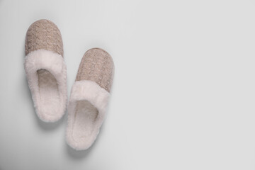 Pair of beautiful soft slippers on white background, top view. Space for text