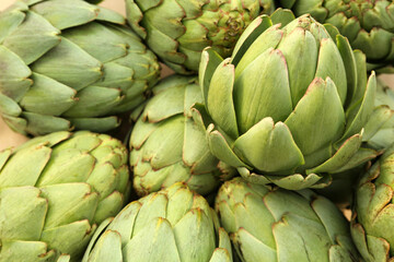 Fototapeta premium Many fresh raw artichokes as background, closeup