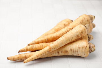 Raw parsley roots on white table, closeup