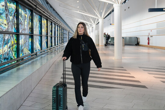 Young woman walking in the airport before traveling