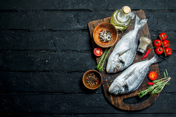 Raw sea fish dorado with spices and rosemary.
