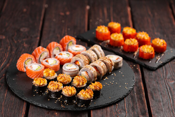 Rolls set with fish shrimp and caviar sushi with chopsticks - asian food and japanese cuisine concept