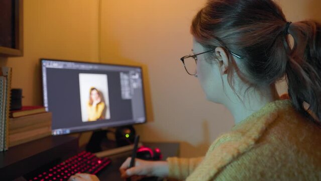 Young creative woman editing photo on desktop computer, home working, entrepreneur, photo editor. 4K 24FPS