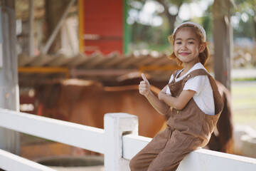 Fototapeta premium Smart farming, A girl is walking and learning at the animal farm.