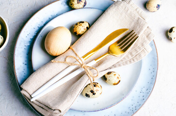 Fototapeta na wymiar Easter Table Setting with Quail Eggs on Grey Background, Festive Happy Easter Concept