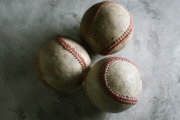 Sports equipment background for baseball with group of old used game balls closeup.
