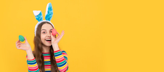 happy easter kid girl in rabbit bunny ears hold colorful eggs for holiday, egg hunt. Easter child horizontal poster. Web banner header of bunny kid, copy space.