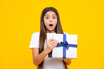 Amazed surprised emotions of young teenager girl. Teenager kid with present box. Teen girl giving birthday gift. Present, greeting and gifting concept.