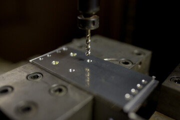 Fototapeta na wymiar Cutting a screw with a tapping machine