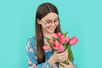 teen girl with spring bouquet on blue background. floral present.