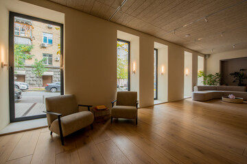 modern armchairs near round coffee table in spacious lobby of hotel.