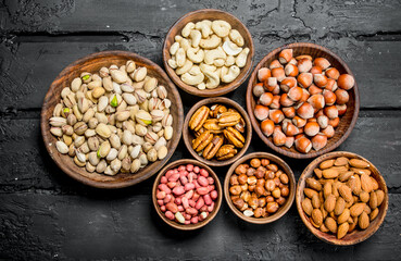 Assortment of different nuts in bowls.