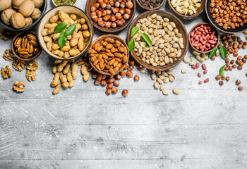 Assortment of different nuts in bowls.