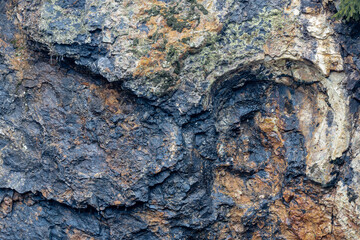 Colorfull stone wall containing minerals.