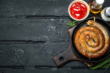 Fried sausages with tomato sauce.