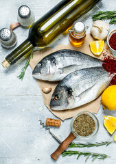Raw sea fish dorado with white wine and spices.