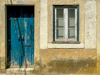 Traditional and vintage Portuguese house style, Dark blue wooden window and door, Old white cream cement concrete wall, Lisbon is capital city of Portugal.