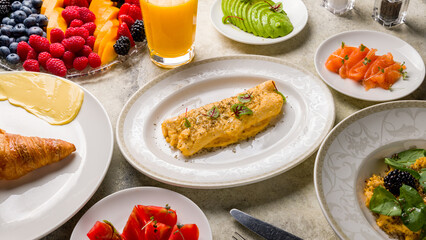 classic omelet with truffle on plate on stone table