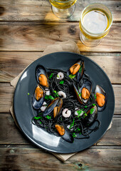 Mediterranean food. Spaghetti with cuttlefish ink, clams and white wine.