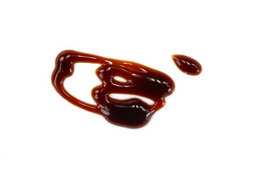 A drop of balsamic vinegar isolated on white background. Balsamic vinegar cream isolated on white background. Italian salad dressing, sauce.
