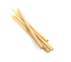 Bamboo straws isoalted on white background. Drinking straws from bamboo wood for reusing and reducing the use of plastic straw. Brown disposable drinking straws, eco-friendly cocktail tubes.