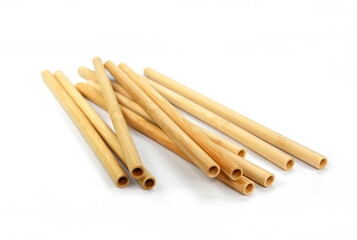 Bamboo straws isoalted on white background. Drinking straws from bamboo wood for reusing and reducing the use of plastic straw. Brown disposable drinking straws, eco-friendly cocktail tubes.