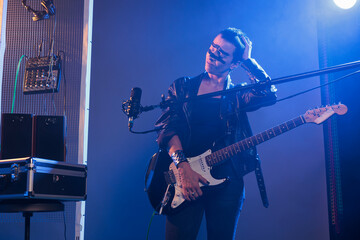 Woman rock artist feeling miserable with headache, dealing with pressure and tension before...