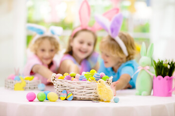Kids on Easter egg hunt. Children dye eggs.