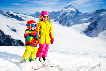 Fototapeta na wymiar Kids winter snow sport. Children ski. Family skiing.