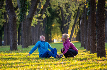 Senior couple exercising in park and man have injury and pain
