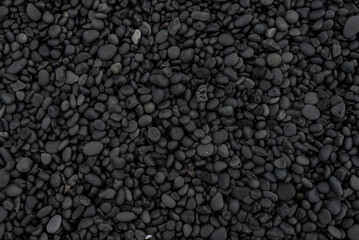 Fototapeta na wymiar Beautiful black lava stone background texture, full frame shot of the black pebbles at Djúpalónssandur beach, Iceland