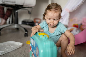 One girl small caucasian toddler playing at home in summer day