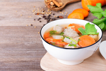 Clear Soup with Minced Pork Carrots Tofu Thai and Asian Food, Healthy Nutrition Placed on a wooden table