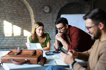 Business people discussing over new business project in office