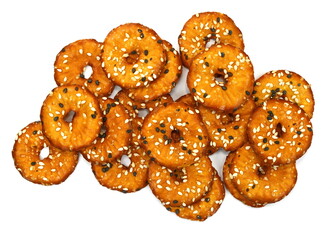 Salted round pretzels with black and white sesame isolated on white. Cracker chips with sea salt isolated on white background. Round shape appetizers. Salty crackers with sesame isolated 