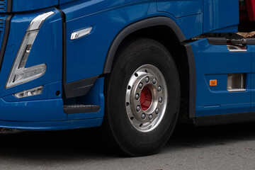 Front wheel of a blue truck. Close-up.