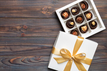 White box with chocolates candies and golden tape. top view with copy space