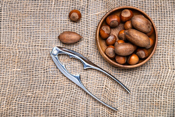 Different nuts and nutcracker close up. View from above.