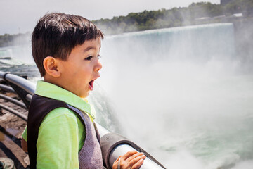 Little boy looking in awe at Niagara Falls