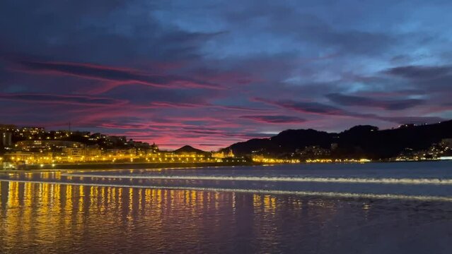 Beautiful colours sunset sky at La Contxa bay in San Sebastian, Spain