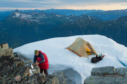 A Climber Preparing A Hot Drink While Camping On The Summit Of A Joffre Peak
