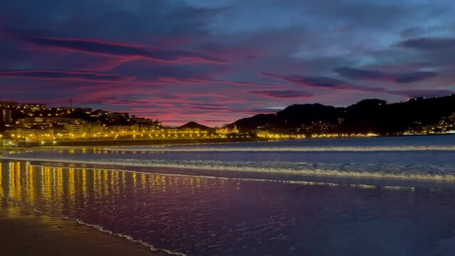 Beautiful colours sunset sky at La Contxa bay in San Sebastian, Spain