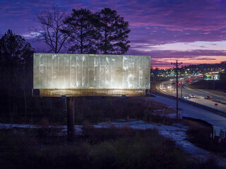 Empty lighted billboard at dusk
