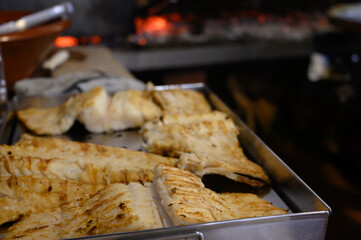 Cod fish salted bacalhau grilled on olive wood firewood grill in small village restaurant in Portugal