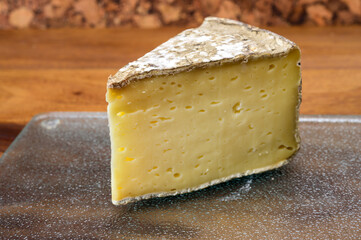 Pieces of cheese tomme de montagne or tomme de savoie made from cow milk in French Alps