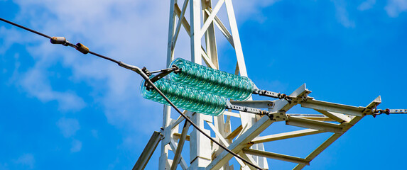 Line insulator on the electrical wires of a high-voltage tower. Electric wires. High-voltage power...